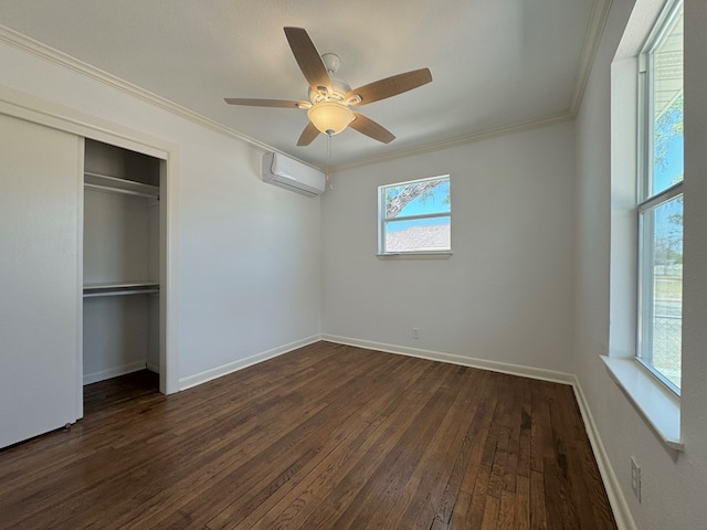 unfurnished bedroom featuring crown molding, ceiling fan, a wall mounted air conditioner, and dark hardwood / wood-style flooring