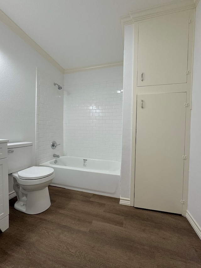 full bathroom featuring crown molding, hardwood / wood-style floors, tiled shower / bath combo, vanity, and toilet