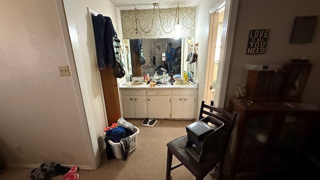 2819 Lindenwood Dr, San Angelo, TX 76904 - bathroom with a textured ceiling, double vanity, and a sink