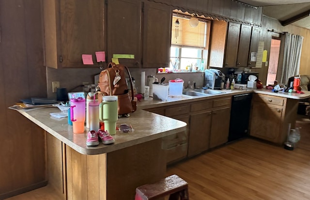 2819 Lindenwood Dr, San Angelo, TX 76904 - kitchen featuring light wood finished floors, a sink, black dishwasher, a peninsula, and light countertops