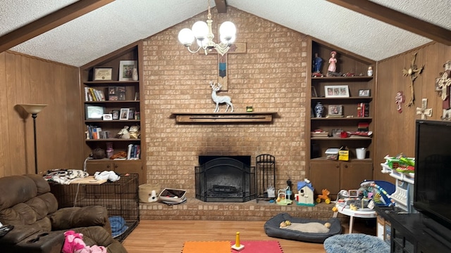 2819 Lindenwood Dr, San Angelo, TX 76904 - living area with lofted ceiling with beams, wood finished floors, a chandelier, and a textured ceiling