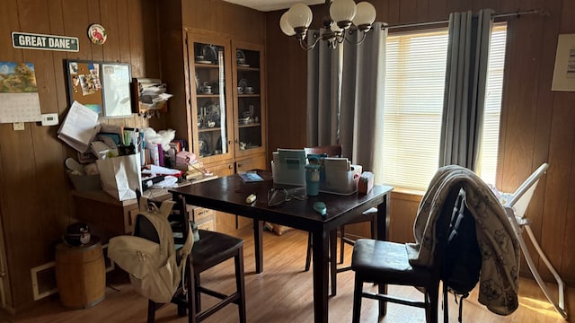 2819 Lindenwood Dr, San Angelo, TX 76904 - dining space with a notable chandelier, visible vents, wooden walls, and wood finished floors