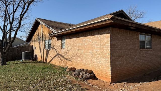 2819 Lindenwood Dr, San Angelo, TX 76904 - view of side of home with cooling unit, brick siding, and fence