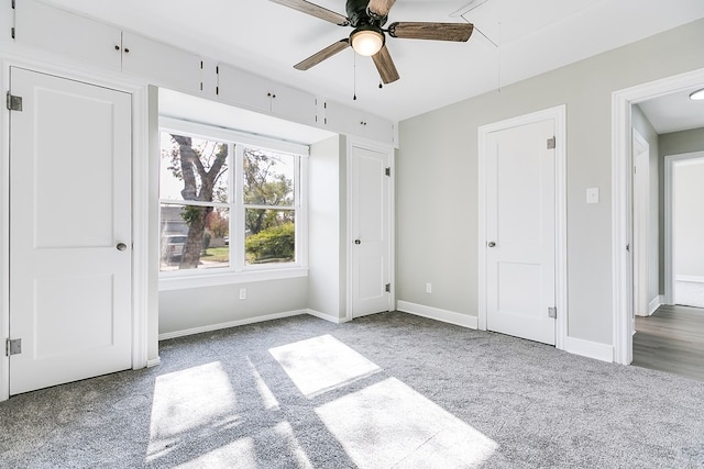 unfurnished bedroom featuring ceiling fan, carpet flooring, attic access, and baseboards