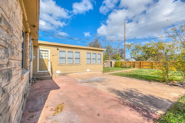 exterior space featuring an outbuilding and fence