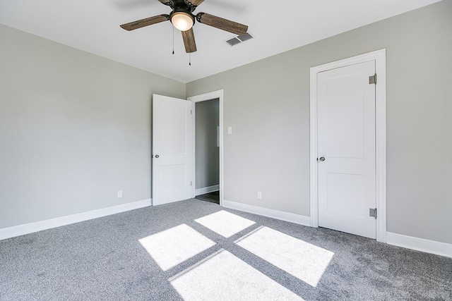 unfurnished bedroom with baseboards, visible vents, ceiling fan, and carpet flooring