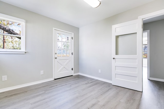 interior space featuring baseboards and wood finished floors