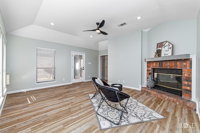 3421 Clearview Dr, San Angelo, TX 76904 - living area with lofted ceiling, a ceiling fan, wood finished floors, a brick fireplace, and recessed lighting
