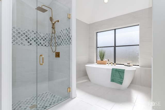 3421 Clearview Dr, San Angelo, TX 76904 - bathroom featuring a shower stall, a soaking tub, tile patterned flooring, tile walls, and lofted ceiling
