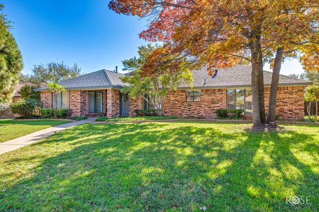 3421 Clearview Dr, San Angelo, TX 76904 - ranch-style house with a front lawn, brick siding, and a shingled roof