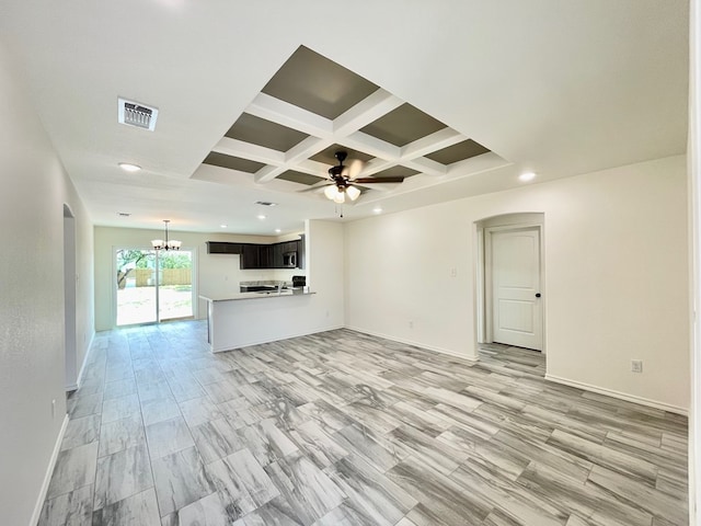 2009 Hudson St, San Angelo, TX 76903 - unfurnished living room with coffered ceiling, arched walkways, a ceiling fan, beam ceiling, and baseboards