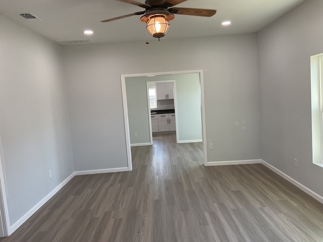 spare room featuring hardwood / wood-style flooring and ceiling fan