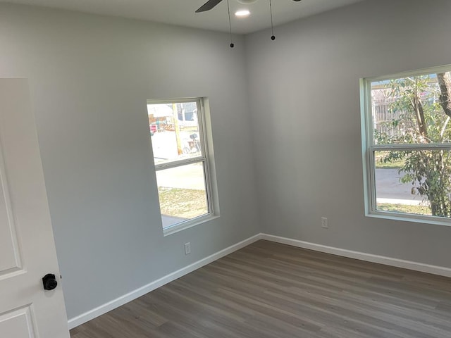 empty room with dark hardwood / wood-style flooring and ceiling fan