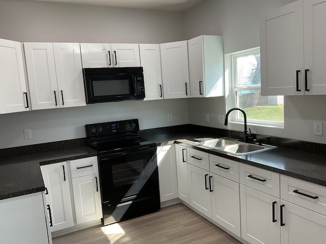 kitchen with sink, white cabinets, and black appliances