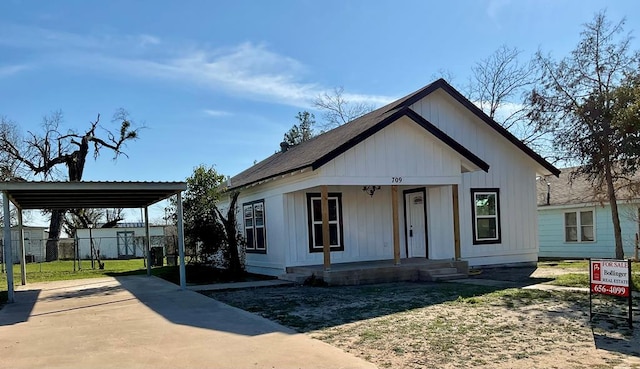 view of front of home with a carport and a porch