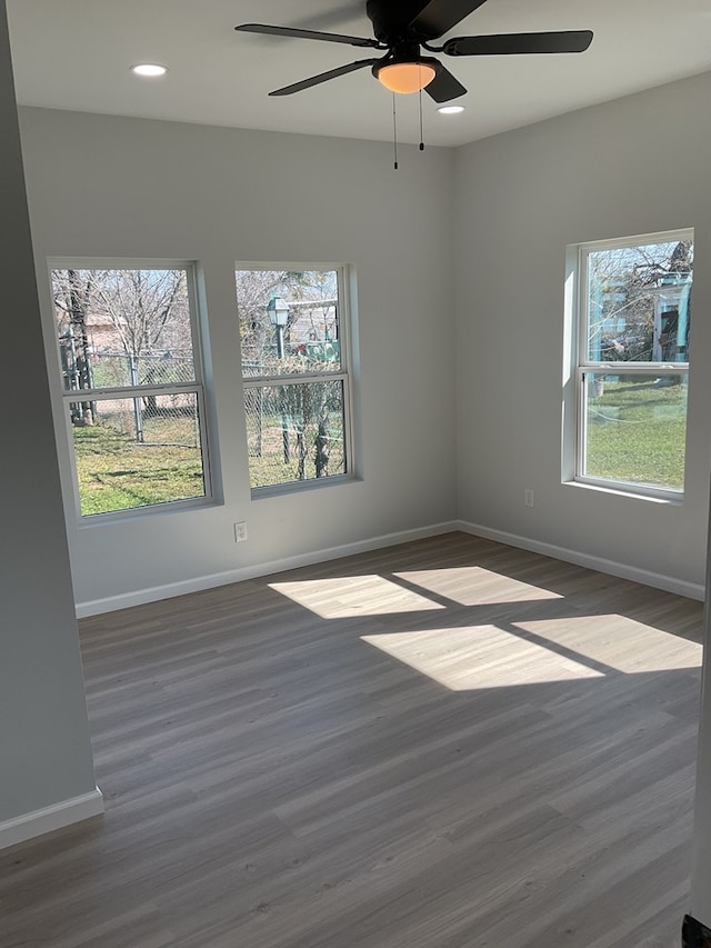 unfurnished room featuring dark wood-type flooring and ceiling fan