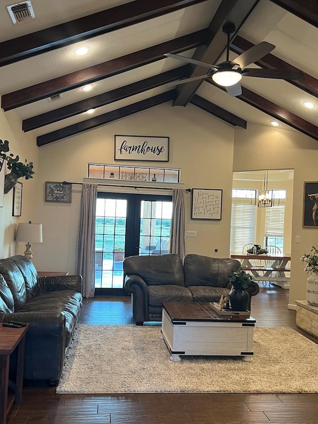 living room featuring ceiling fan with notable chandelier, dark wood-type flooring, and lofted ceiling with beams