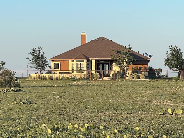 rear view of property with a yard