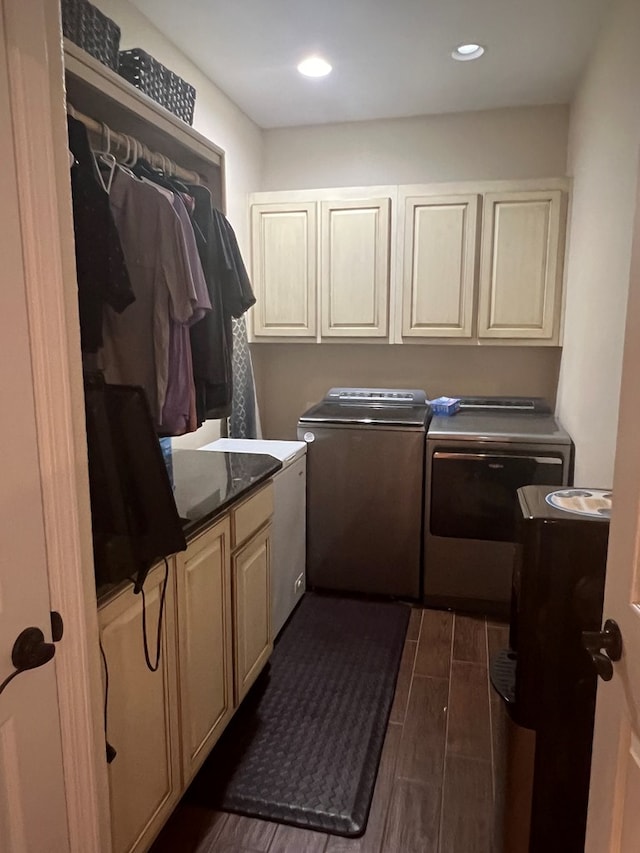 laundry area with independent washer and dryer and cabinets