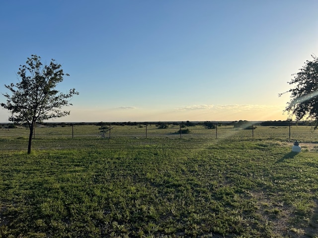 yard at dusk with a rural view