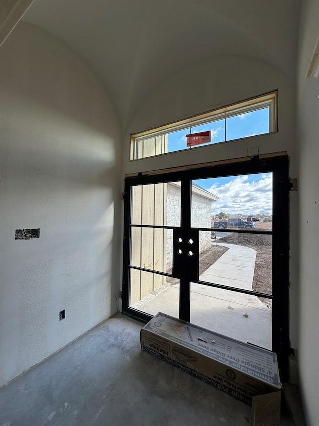 entryway with concrete floors and french doors