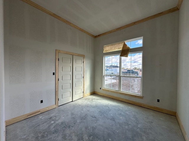 unfurnished room featuring crown molding