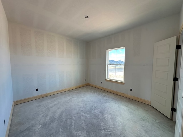 spare room with concrete floors