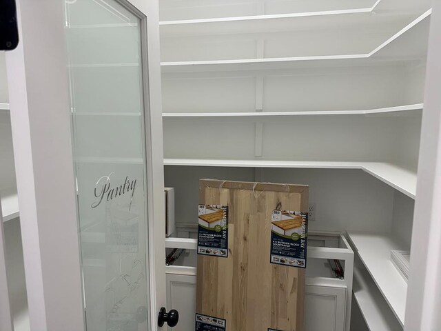 kitchen featuring crown molding, concrete flooring, and a raised ceiling