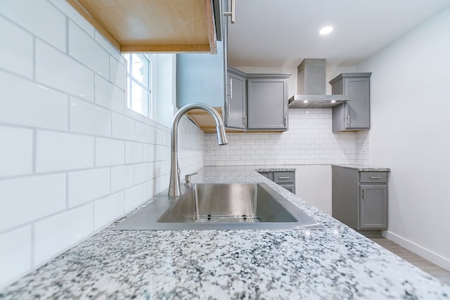 2624 Dallas St, San Angelo, TX 76903 - kitchen with gray cabinetry, wall chimney exhaust hood, a sink, tasteful backsplash, and recessed lighting