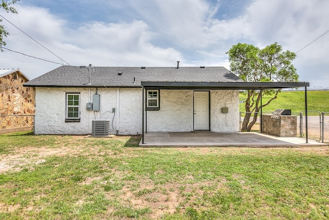 2624 Dallas St, San Angelo, TX 76903 - back of property featuring a patio area, area for grilling, a shingled roof, stucco siding, and central AC