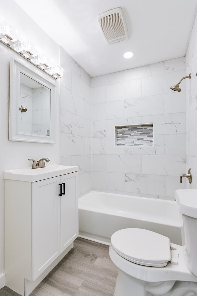 2624 Dallas St, San Angelo, TX 76903 - full bath with shower / bathtub combination, wood finished floors, vanity, toilet, and recessed lighting