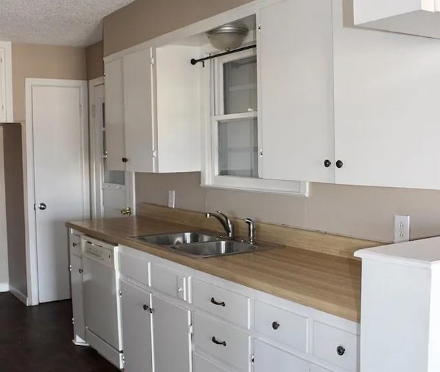 kitchen featuring a sink, a textured ceiling, dishwasher, and white cabinets