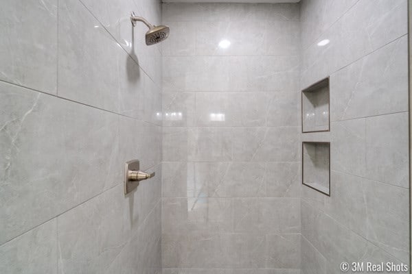 bathroom with tiled shower