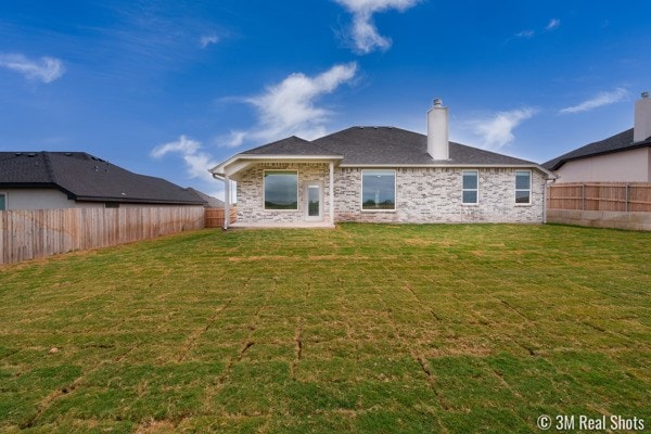 back of house featuring a yard