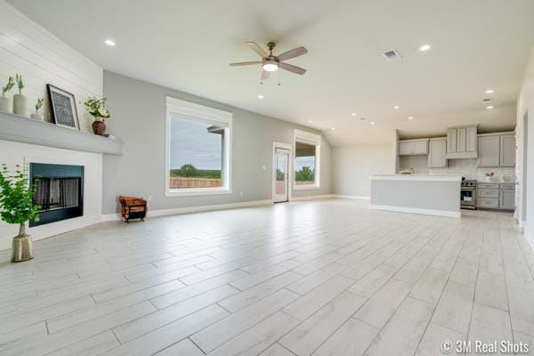 unfurnished living room featuring ceiling fan