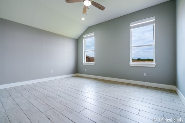 unfurnished room featuring vaulted ceiling, light wood-type flooring, and ceiling fan