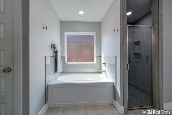 bathroom with separate shower and tub