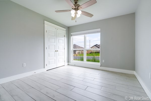 spare room featuring ceiling fan and light hardwood / wood-style floors