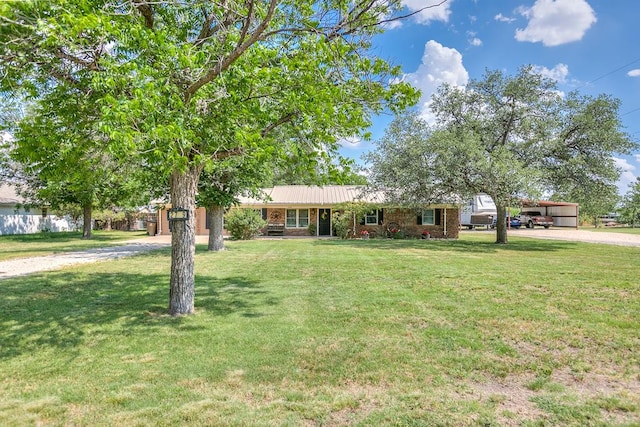 2709 Janie Ln, San Angelo, TX 76905 - single story home with dirt driveway, a front yard, a carport, and metal roof
