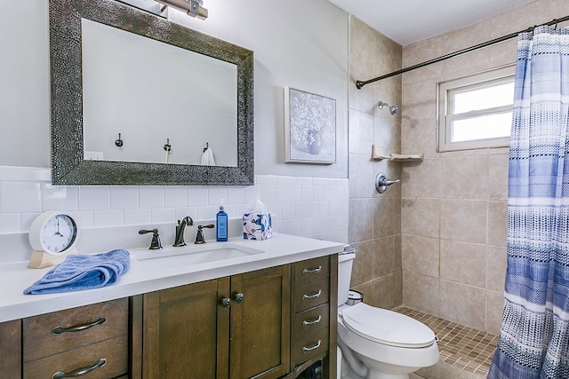2709 Janie Ln, San Angelo, TX 76905 - full bathroom featuring toilet, vanity, tiled shower, and tile walls