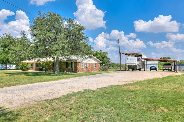 2709 Janie Ln, San Angelo, TX 76905 - view of front facade with dirt driveway, a front yard, and brick siding