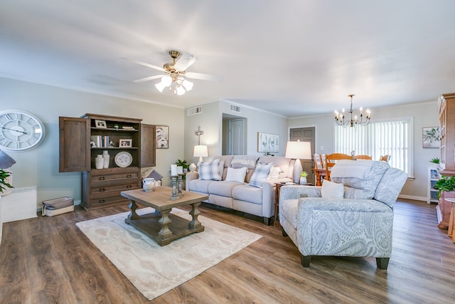 2709 Janie Ln, San Angelo, TX 76905 - living room featuring a chandelier, dark wood-style floors, a ceiling fan, and ornamental molding