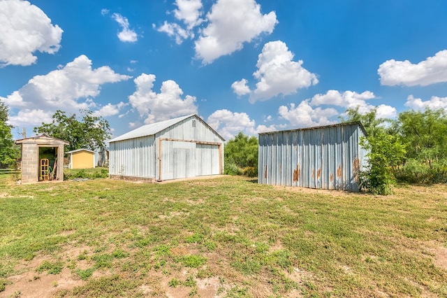 2709 Janie Ln, San Angelo, TX 76905 - view of green lawn featuring a pole building, an outbuilding, and a detached garage