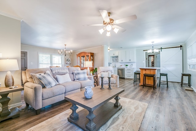 2709 Janie Ln, San Angelo, TX 76905 - living area featuring ornamental molding, a chandelier, a barn door, a ceiling fan, and wood finished floors