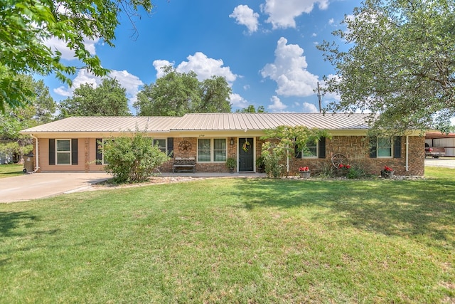 2709 Janie Ln, San Angelo, TX 76905 - single story home featuring a front lawn, metal roof, brick siding, and a standing seam roof