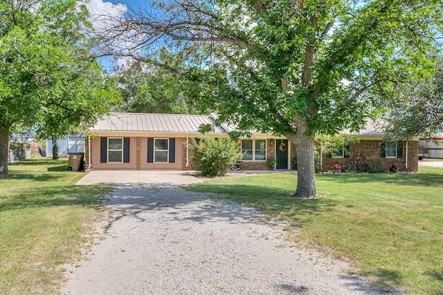 2709 Janie Ln, San Angelo, TX 76905 - ranch-style home with driveway, metal roof, and a front yard