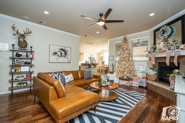 living room featuring crown molding, ceiling fan, and dark hardwood / wood-style floors