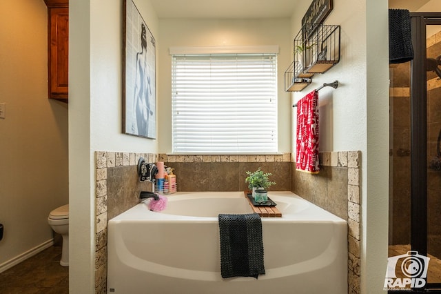 bathroom featuring toilet and a tub