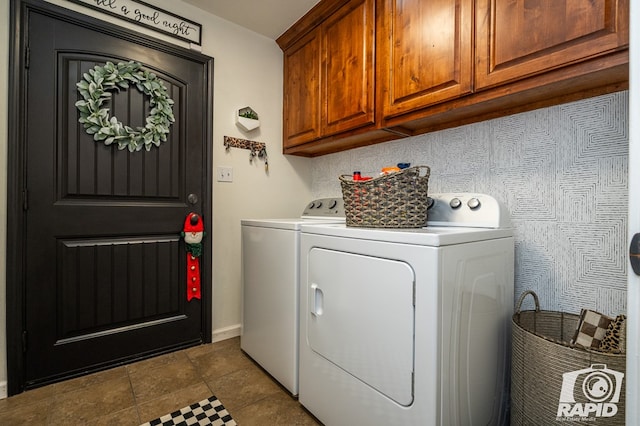 washroom featuring cabinets and independent washer and dryer