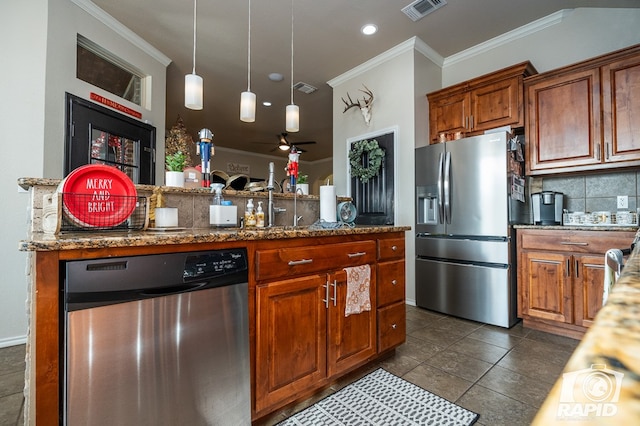 kitchen with appliances with stainless steel finishes, decorative light fixtures, backsplash, dark stone counters, and crown molding